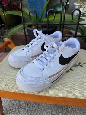 Nike White Sneakers with Black Swoosh and Tan Accent